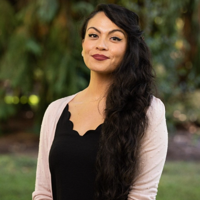 Headshot of Mariah Helm smiling wearing light sweater and dark shirt.