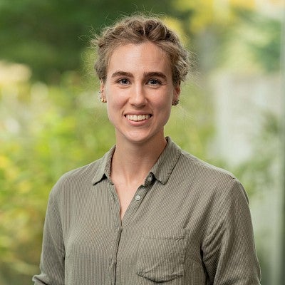 Headshot of Brynne Loudon smiling wearing light green shirt.