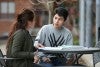 Two students talking over school work.